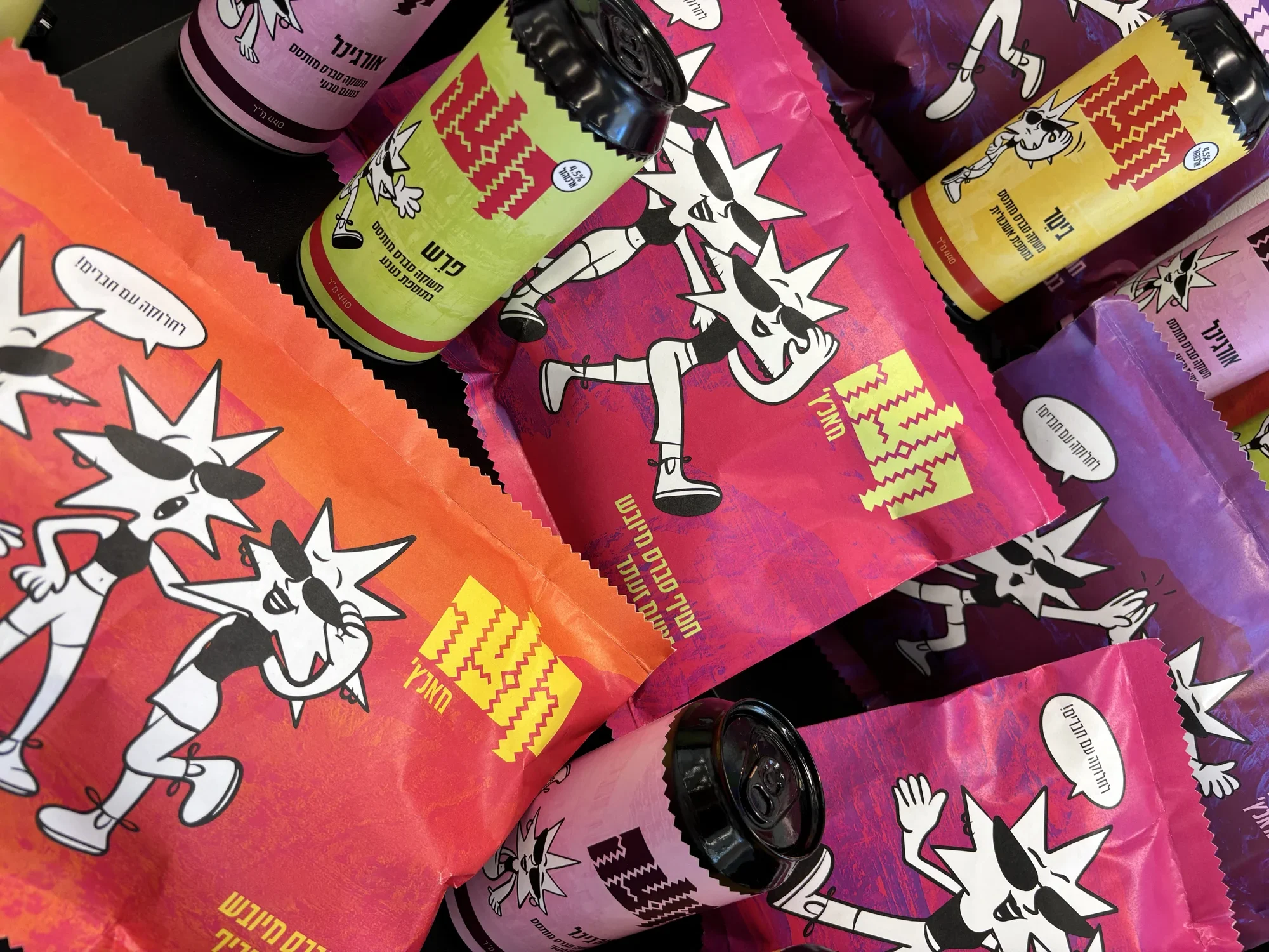 Close-up of Kutza snack bags and cans lying together
